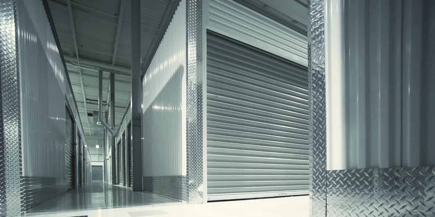 Storage facility corridor with open and closed roller doors